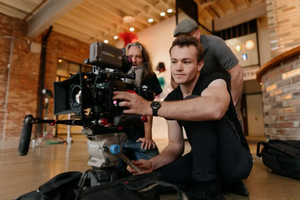 Behind the scenes of a brand video production crew filming a company introduction video with a professional cinema camera.